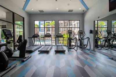 a gym with treadmills and elliptical machines at The Edge at Millenia in Orlando