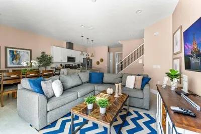 a living room with a couch and a table at 5-Suite Disney Escape: Minutes from the Magic in Orlando