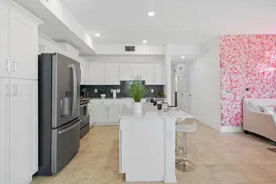 a kitchen with white cabinets and a black refrigerator at 3191 Paradox Circle 202 in Kissimmee