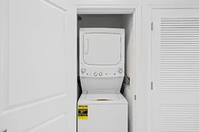 a white machine sitting on top of a refrigerator at 3191 Paradox Circle 202 in Kissimmee