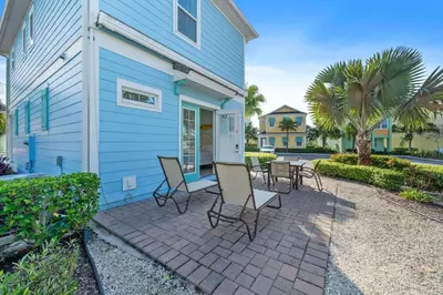 a patio in front of a blue house at 3050 Pirate Way in Orlando
