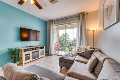 a living room with a couch and a tv at 6 Mi to Disney Kissimmee Resort Vacation Rental! in Kissimmee