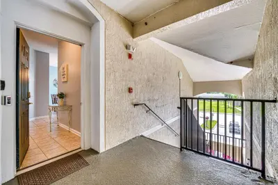 an empty hallway with a staircase in a house at 6 Mi to Disney Kissimmee Resort Vacation Rental! in Kissimmee