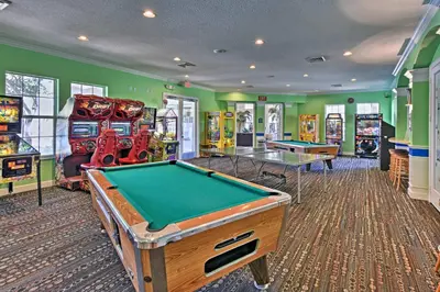 a gaming room with a pool table and arcade machines at 6 Mi to Disney Kissimmee Resort Vacation Rental! in Kissimmee