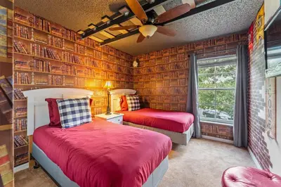 two beds in a room with wooden walls at Harry Potter Themed 3 BR - ER2782 in Kissimmee