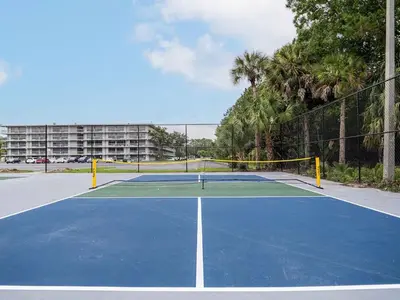 a tennis court with a net on top of it at Modern Orlando 1BR Home & minutes to Disney in Kissimmee