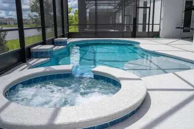 a pool with a hot tub in a building at Sea World neighbor Deluxe Home Up to 33 ppl 5800 in Orlando
