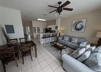 a living room with a couch and a dining room at Beautiful 3 bed townhome in Windsor Hills Resort townhouse in Orlando