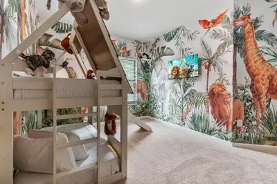 a childs room with a mural of giraffes at Brand New 5BedroomsPool LED At Paradiso Grande in Orlando