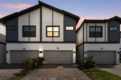 a house with a garage in front of it at Cozy New 5Bedrooms At Paradiso Grande in Orlando