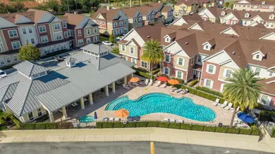 an aerial view of a swimming pool in a residential neighborhood at 2024 Coastal Villa 3 suites near Disney in Orlando