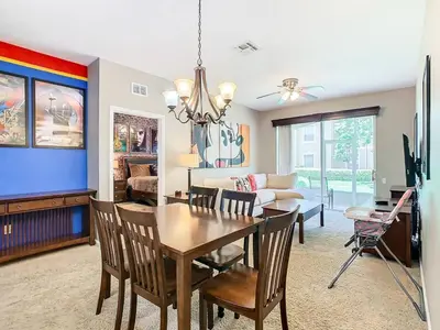a dining room and living room with a table and chairs at C2784-102 Themed Room Free Resort Water Park 3 miles to Disney in Orlando
