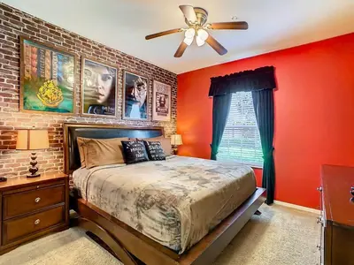 a bedroom with red walls and a bed with a ceiling fan at C2784-102 Themed Room Free Resort Water Park 3 miles to Disney in Orlando