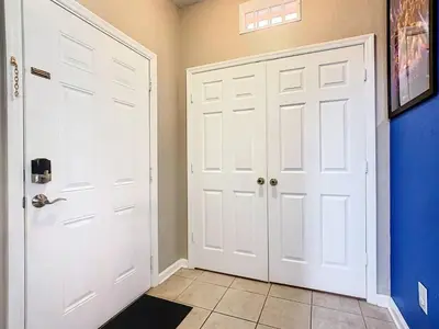 a hallway with two white doors and blue walls at C2784-102 Themed Room Free Resort Water Park 3 miles to Disney in Orlando
