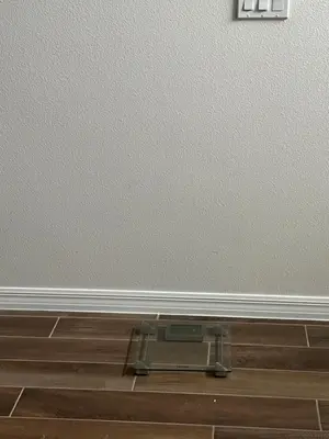 a scale on the floor in front of a wall at Sleeps8- WorldCup2026- NearDisney- Universal in Kissimmee
