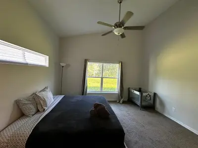 a bedroom with a bed and a ceiling fan at Sleeps8- WorldCup2026- NearDisney- Universal in Kissimmee