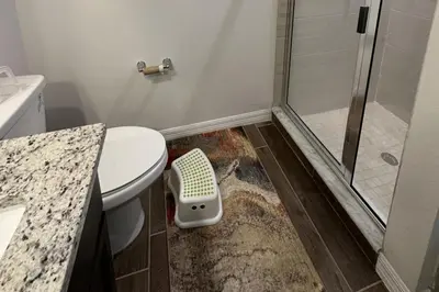 a bathroom with a shower with a toilet and a sink at Sleeps8- WorldCup2026- NearDisney- Universal in Kissimmee