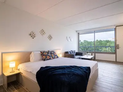 a bedroom with a large bed and a large window at Central Orlando 1BR Retreat & minutes to Disney Parks in Kissimmee