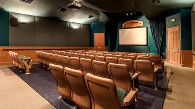 an auditorium with a lecture hall with chairs and a screen at 2304 Silver Palms #205 in Kissimmee