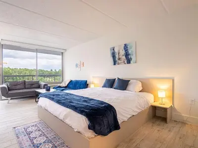 a bedroom with a large bed and a large window at Orlando Paradise 1BR With view & minutes to Disney in Kissimmee