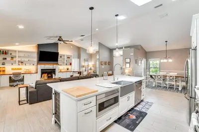 a kitchen and living room with a couch and a table at Screened Lanai and Fenced Yard Luxe Orlando Home in Orlando