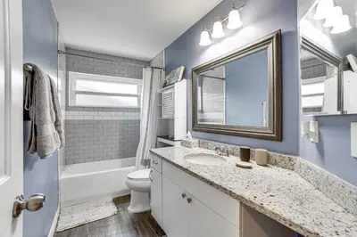 a bathroom with a sink and a toilet and a window at Screened Lanai and Fenced Yard Luxe Orlando Home in Orlando