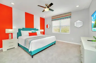 a bedroom with red and white walls and a bed at Upstay Sleeps 26 w Private Pool, Hot Tub, Games in Kissimmee