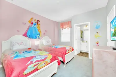 two beds in a room with a disney princess bedroom at Upstay Sleeps 26 w Private Pool, Hot Tub, Games in Kissimmee