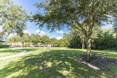 a park with a picnic table and a tree at Modern 4 BR Townhouse near Disney in Kissimmee