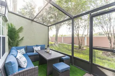 a patio with a blue couch and a table at Modern 4 BR Townhouse near Disney in Kissimmee