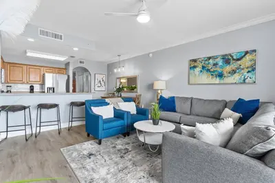 a living room with a couch and a kitchen at Cozy Lakeview Condo near Disney in Orlando