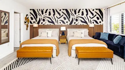 a bedroom with two beds and a couch at Beautiful Zen Nest 1mile New EPIC Universe in Orlando