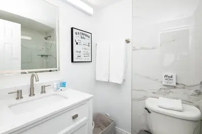 a white bathroom with a sink and a toilet at Beautiful Zen Nest 1mile New EPIC Universe in Orlando