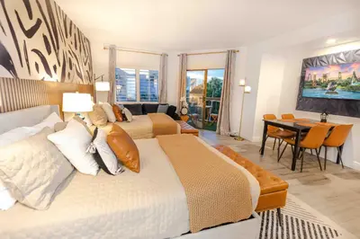 a bedroom with two beds and a dining room at Beautiful Zen Nest 1mile New EPIC Universe in Orlando