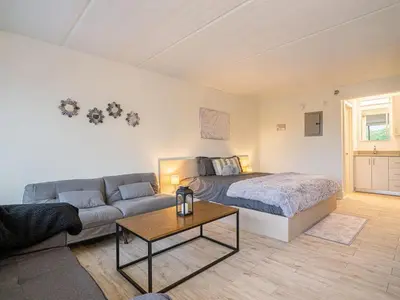 a living room with a bed and a couch at Next to Disney 1BR Retreat in Orlando With Lake view in Kissimmee