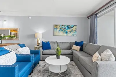 a living room with blue couches and a table at 5-Min to Disney Lakeside Retreat in Orlando