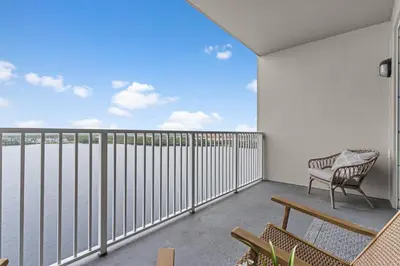 a balcony with a bench and a view of the water at 5-Min to Disney Lakeside Retreat in Orlando