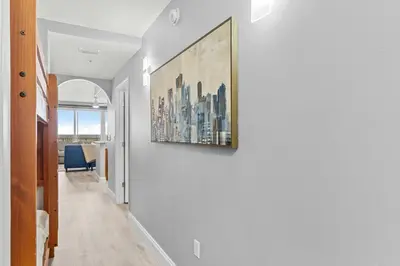 a hallway with a painting hanging on a wall at 5-Min to Disney Lakeside Retreat in Orlando