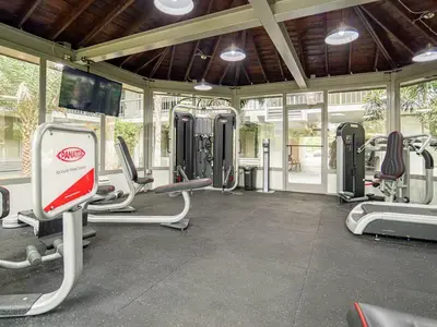 a gym with lots of cardio equipment in a building at Vacation 1BR Rental in Orlando & minutes to Disney in Kissimmee