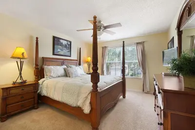 a bedroom with a bed and a ceiling fan at Private Pool, Spa, Game Room & Theme Park Magic in Kissimmee