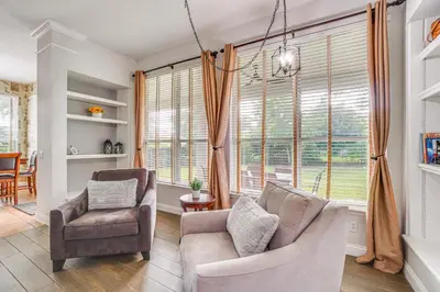 a living room with a couch and a chair at Community Amenities at Spacious Orlando Home! in Orlando