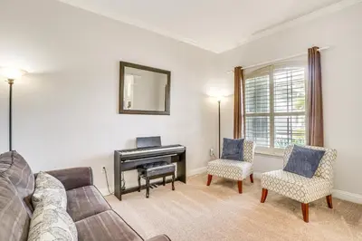 a living room with a couch and a piano at Community Amenities at Spacious Orlando Home! in Orlando