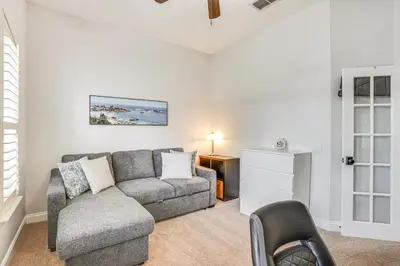 a living room with a couch and a chair at Community Amenities at Spacious Orlando Home! in Orlando