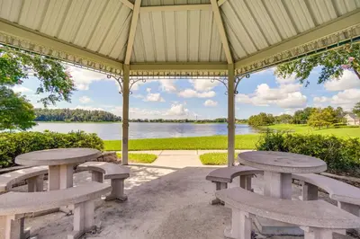a gazebo with benches and a view of a lake at Community Amenities at Spacious Orlando Home! in Orlando