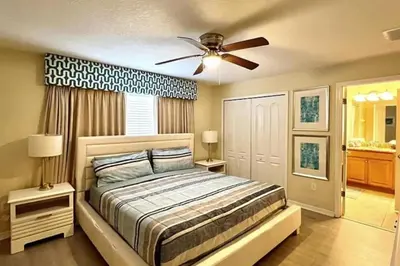 a bedroom with a bed and a ceiling fan at Orlando Area Vacation Rental with private pool in Kissimmee