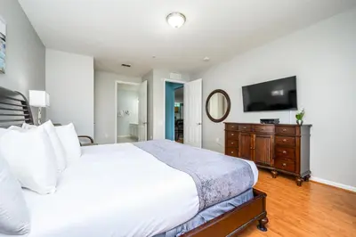 a bedroom with a white bed and a television at Luxury Lakeview, Vista Cay Orlando 1027 in Orlando