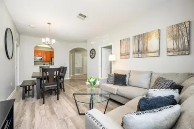a living room with a couch and a table at Epic Universe New Listing Beautiful Vacation Condo - 3018 in Orlando