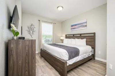 a bedroom with a large bed and a window at Epic Universe New Listing Beautiful Vacation Condo - 3018 in Orlando