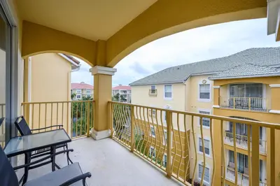 a balcony with a view of two buildings at Beautiful Deluxe Condo, Vista Cay - 3024 in Orlando