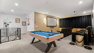 a room with a pool table and a screen at Upstay Family Home w Pool, Cinema & Games Room in Kissimmee